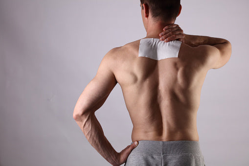 Salonpas-style pain relief patch on shoulder being removed without pain