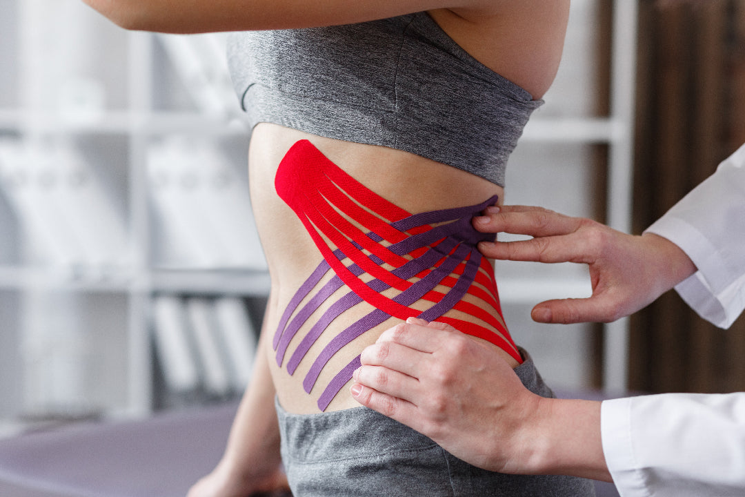 Athlete removing kinesiology sports tape from leg with Sting-Less adhesive remover