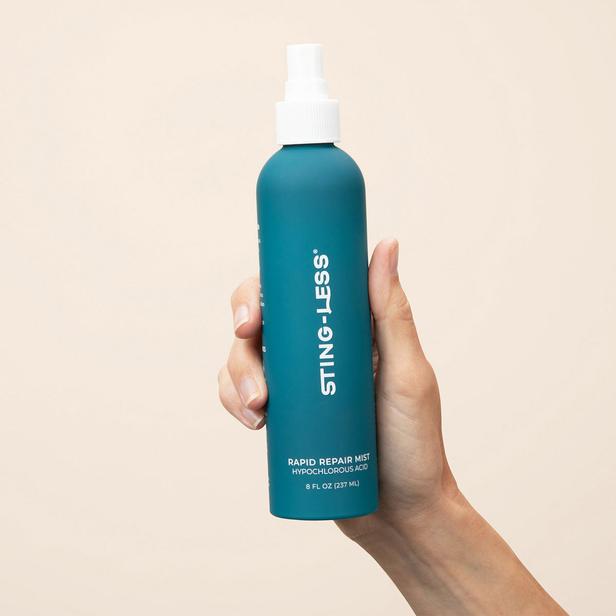 Hand holding Sting-Less hypochlorous acid spray bottle
